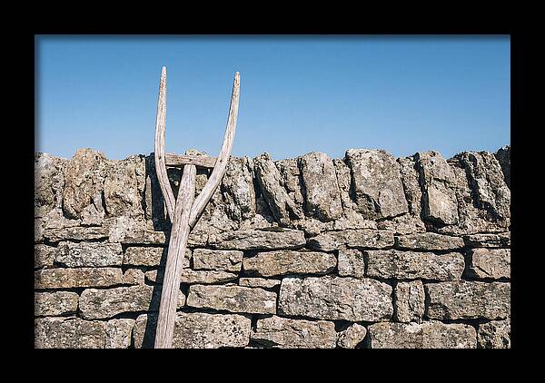 Old Wooden Hay Fork Against Stone Wall
