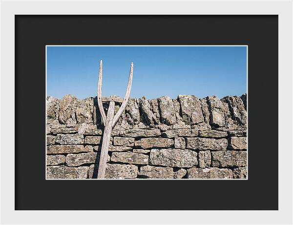 Old Wooden Hay Fork Against Stone Wall
