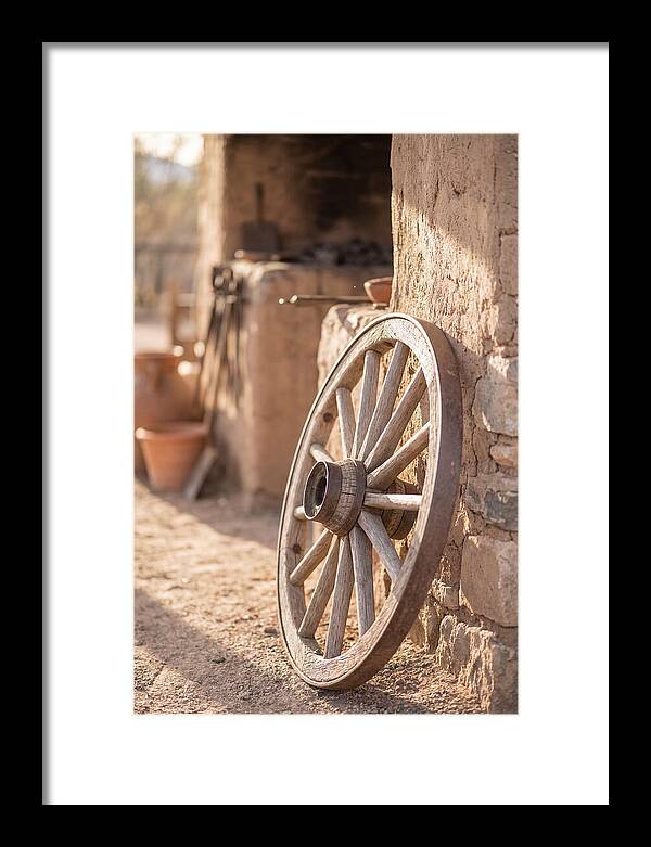 Old Wooden Wheel Against Wall