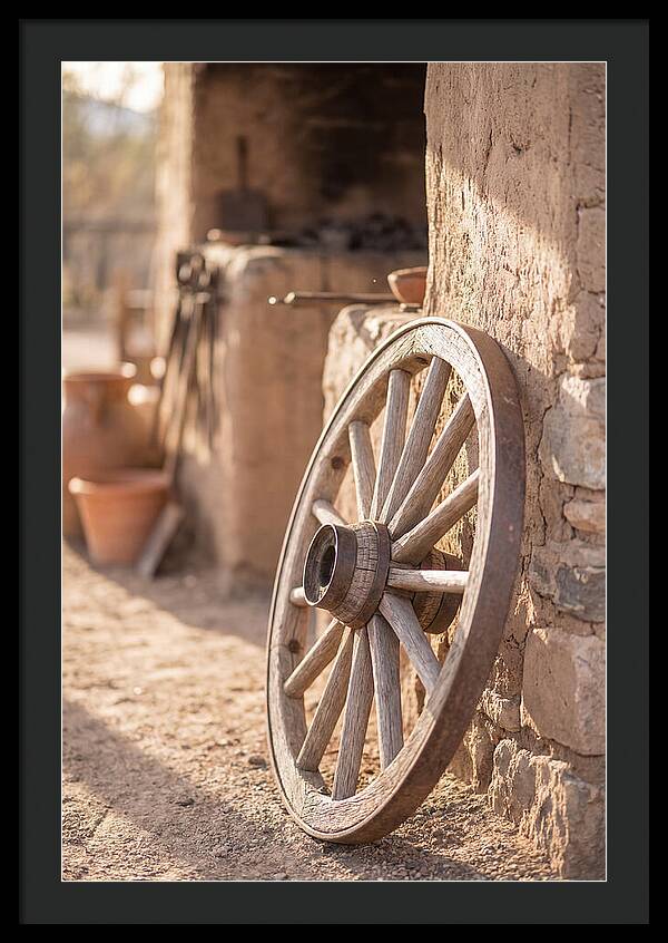 Old Wooden Wheel Against Wall