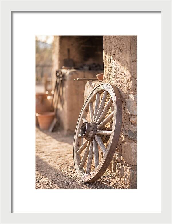 Old Wooden Wheel Against Wall