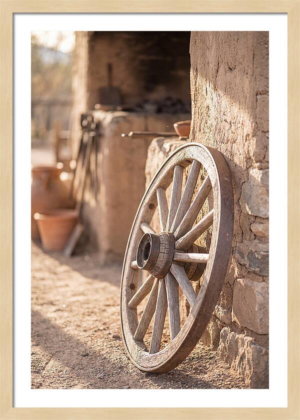 Old Wooden Wheel Against Wall