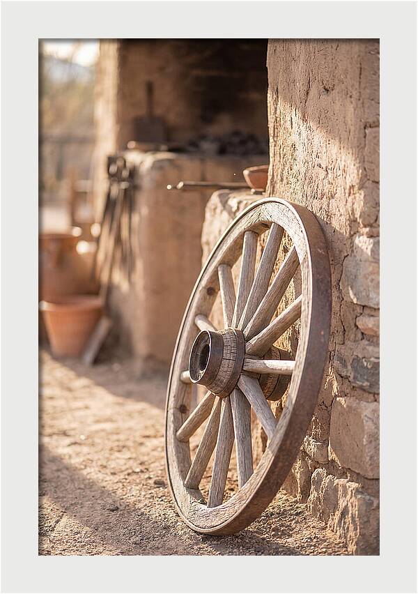 Old Wooden Wheel Against Wall