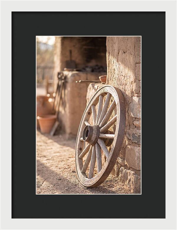 Old Wooden Wheel Against Wall