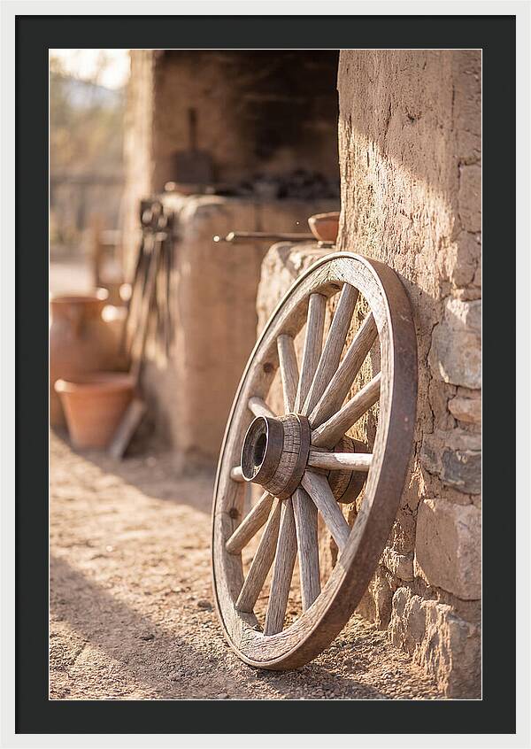 Old Wooden Wheel Against Wall