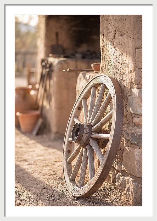 Old Wooden Wheel Against Wall