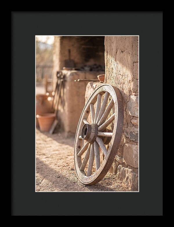 Old Wooden Wheel Against Wall