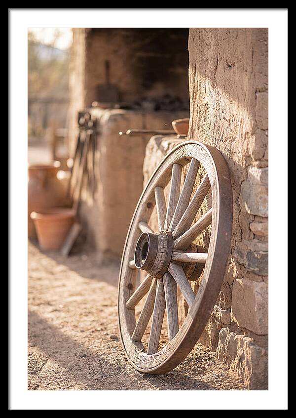 Old Wooden Wheel Against Wall