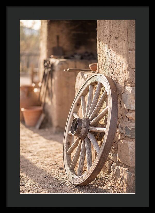 Old Wooden Wheel Against Wall