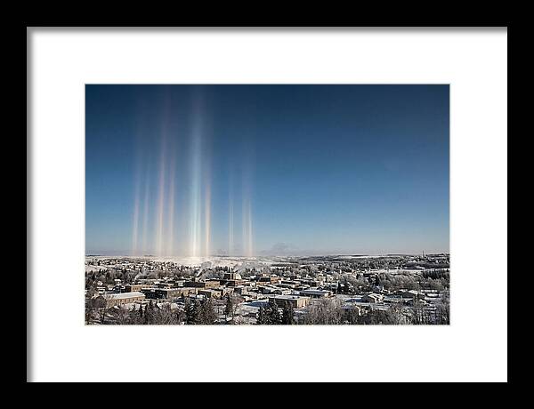 Pillars Of Light Over A Winter Town