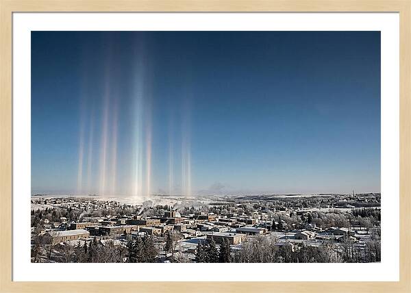 Pillars Of Light Over A Winter Town