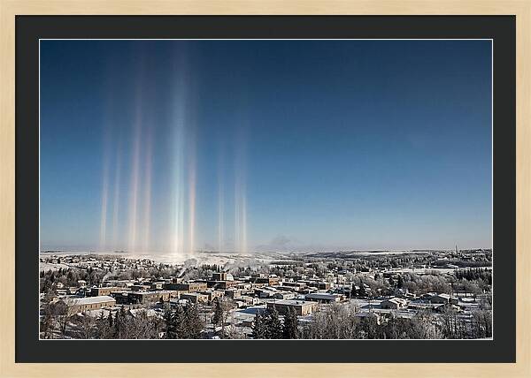 Pillars Of Light Over A Winter Town