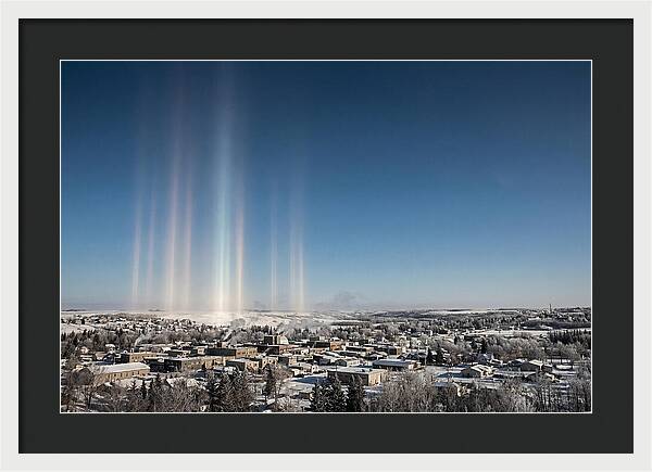 Pillars Of Light Over A Winter Town