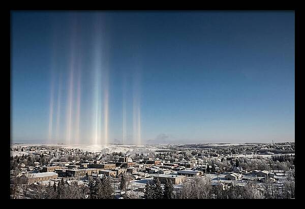 Pillars Of Light Over A Winter Town