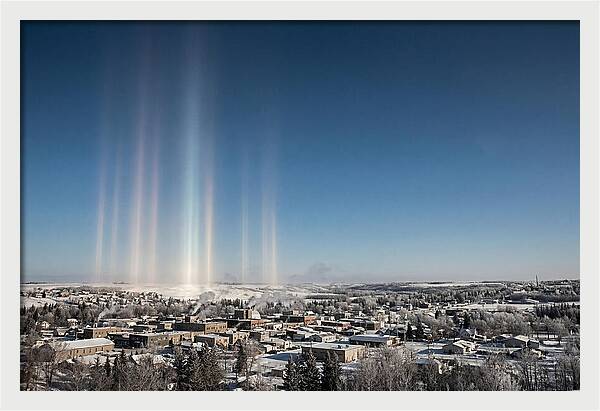 Pillars Of Light Over A Winter Town