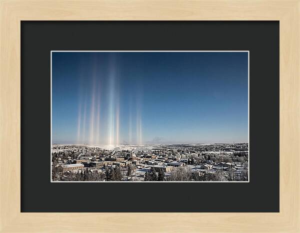 Pillars Of Light Over A Winter Town