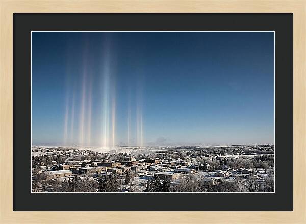 Pillars Of Light Over A Winter Town