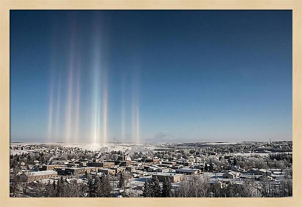 Pillars Of Light Over A Winter Town