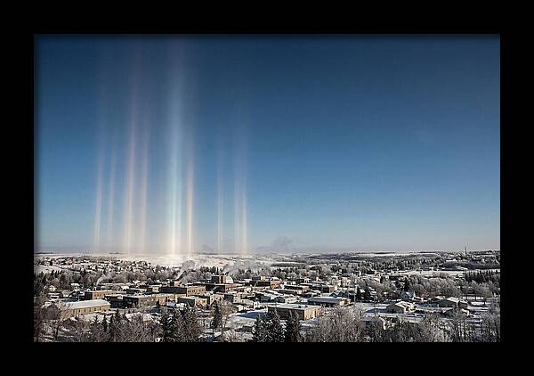 Pillars Of Light Over A Winter Town