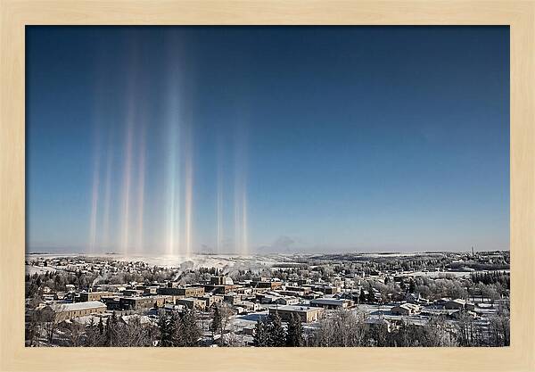 Pillars Of Light Over A Winter Town
