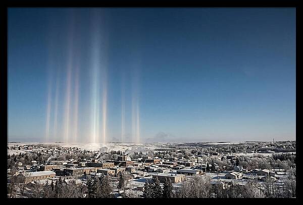 Pillars Of Light Over A Winter Town