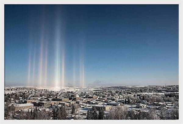 Pillars Of Light Over A Winter Town