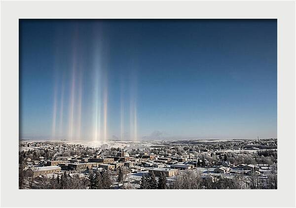 Pillars Of Light Over A Winter Town