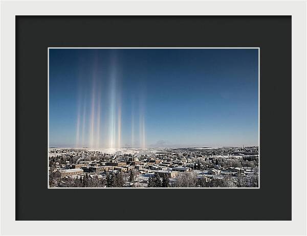 Pillars Of Light Over A Winter Town