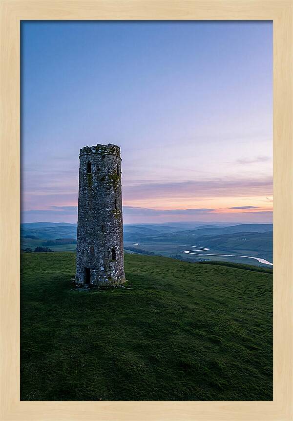 Round Stone Tower On Green Hillside