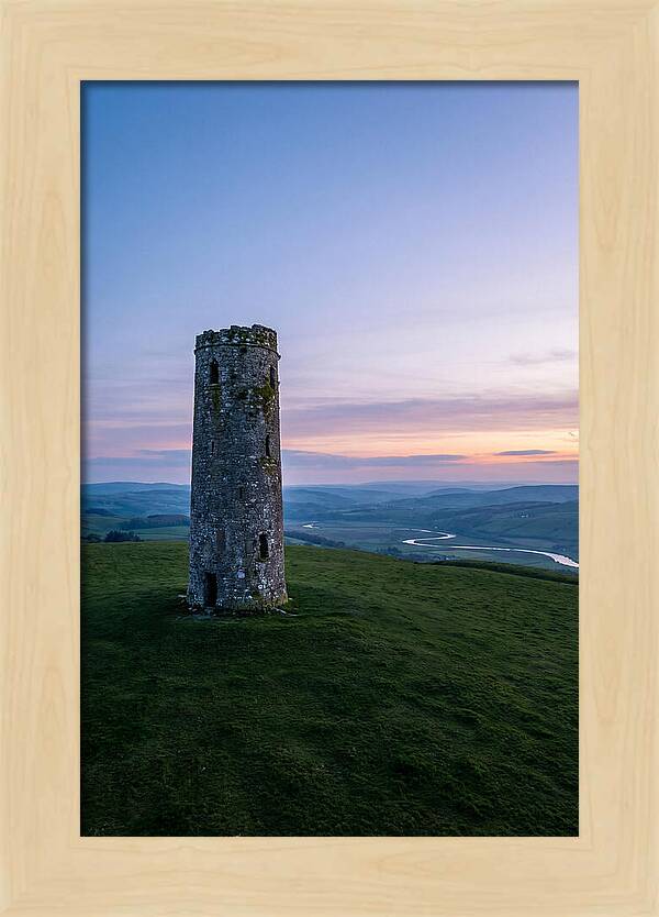 Round Stone Tower On Green Hillside