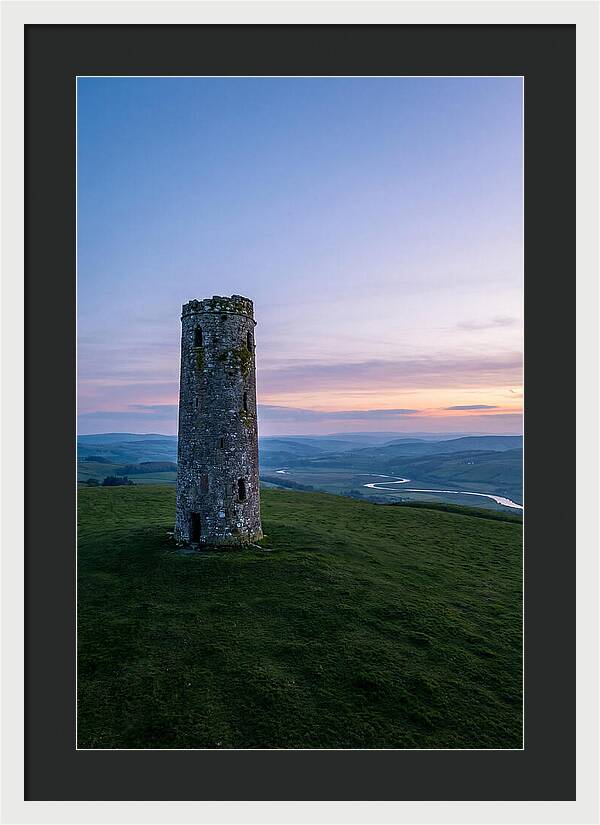 Round Stone Tower On Green Hillside