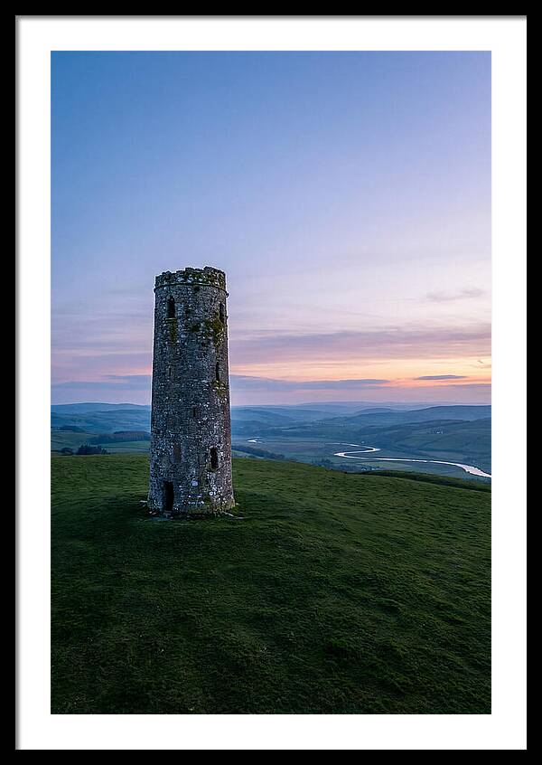 Round Stone Tower On Green Hillside