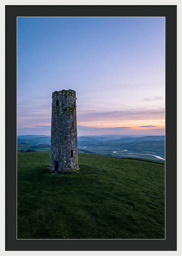 Round Stone Tower On Green Hillside