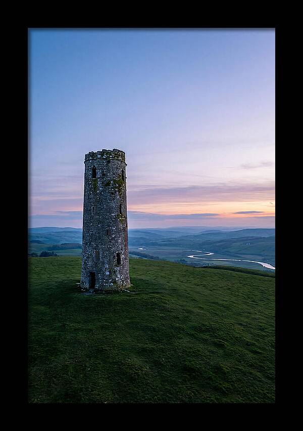 Round Stone Tower On Green Hillside