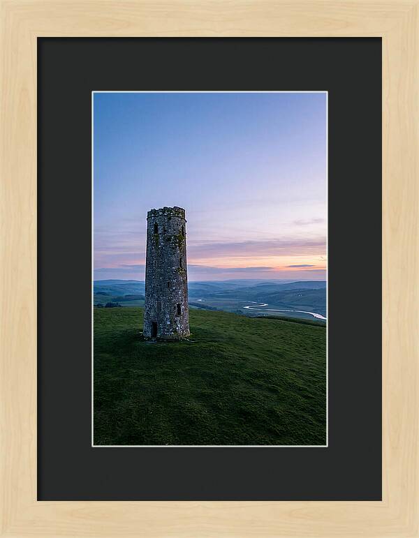 Round Stone Tower On Green Hillside