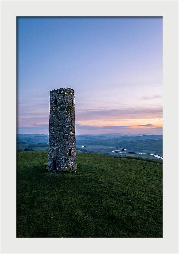 Round Stone Tower On Green Hillside