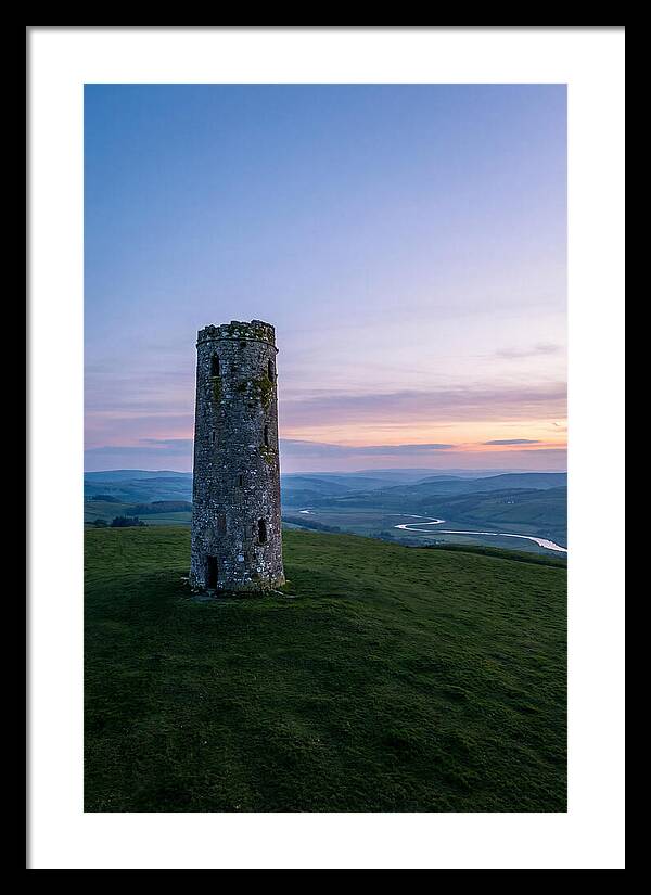 Round Stone Tower On Green Hillside