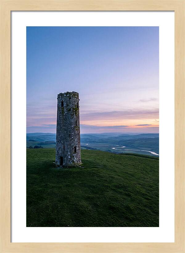 Round Stone Tower On Green Hillside