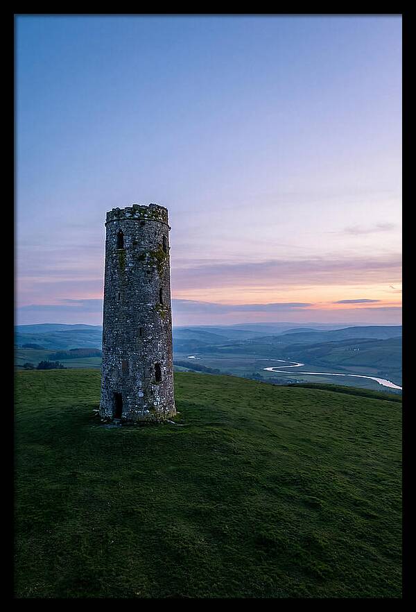 Round Stone Tower On Green Hillside
