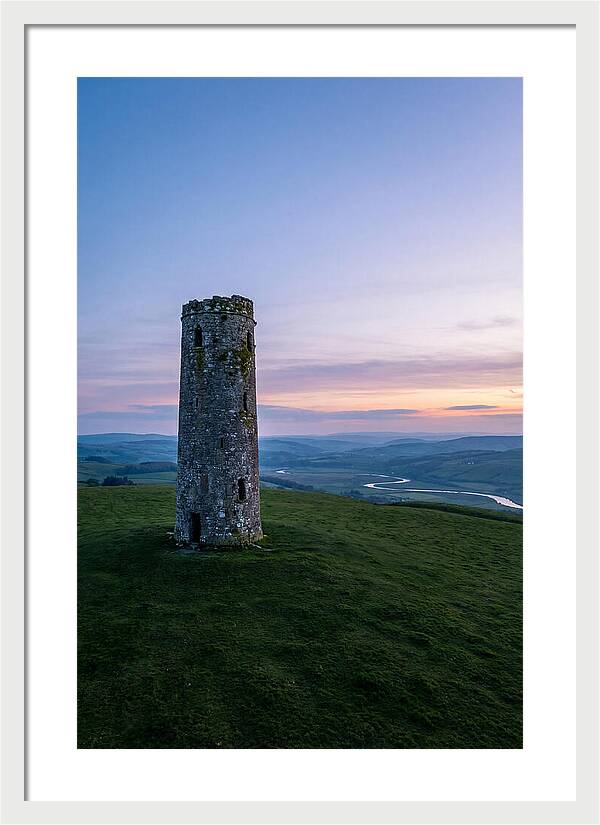 Round Stone Tower On Green Hillside