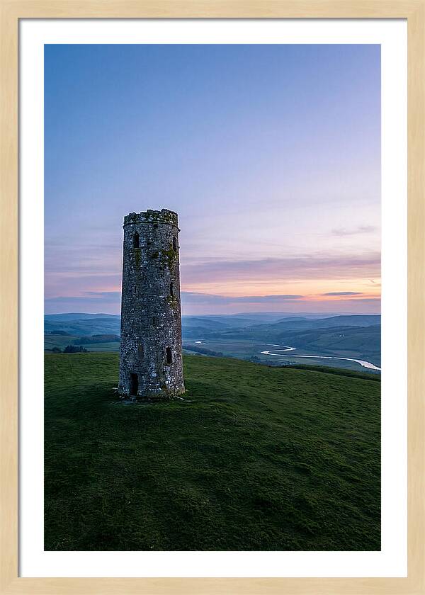 Round Stone Tower On Green Hillside