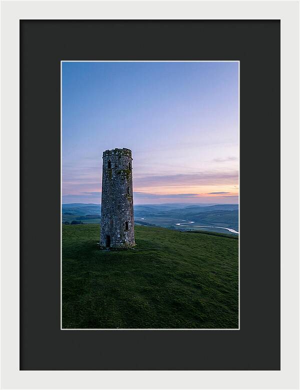Round Stone Tower On Green Hillside