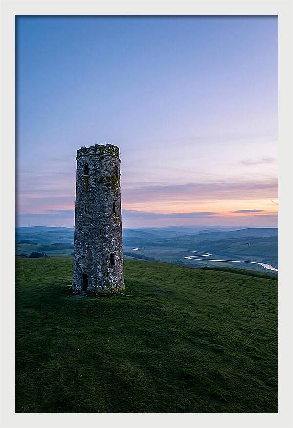 Round Stone Tower On Green Hillside