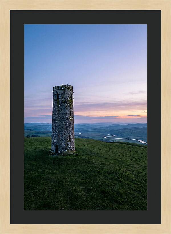 Round Stone Tower On Green Hillside