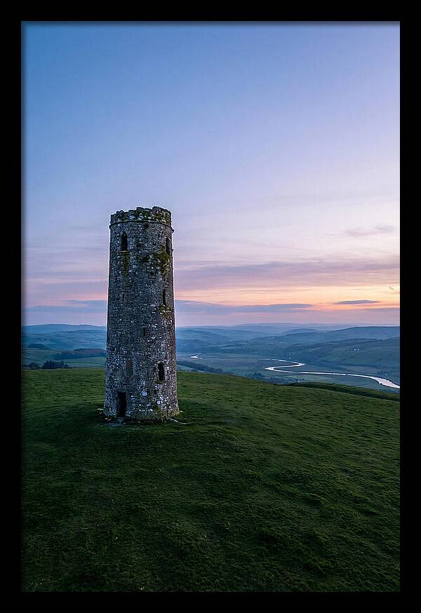 Round Stone Tower On Green Hillside