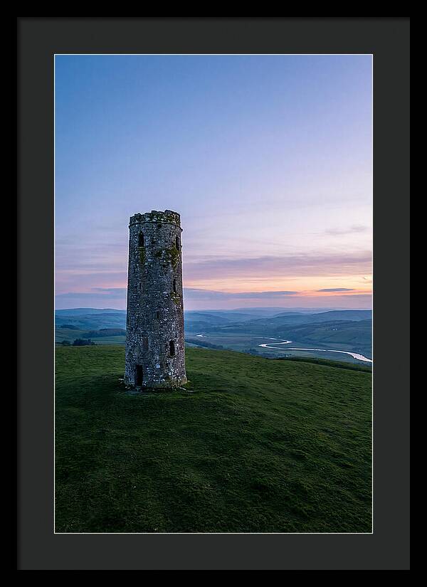 Round Stone Tower On Green Hillside