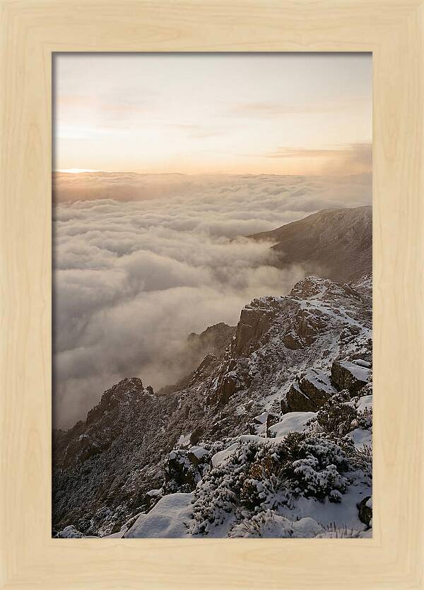 Snow Covered Ridge Line Above Sea Of Clouds
