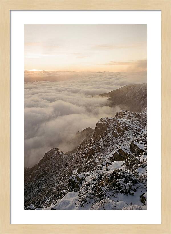 Snow Covered Ridge Line Above Sea Of Clouds