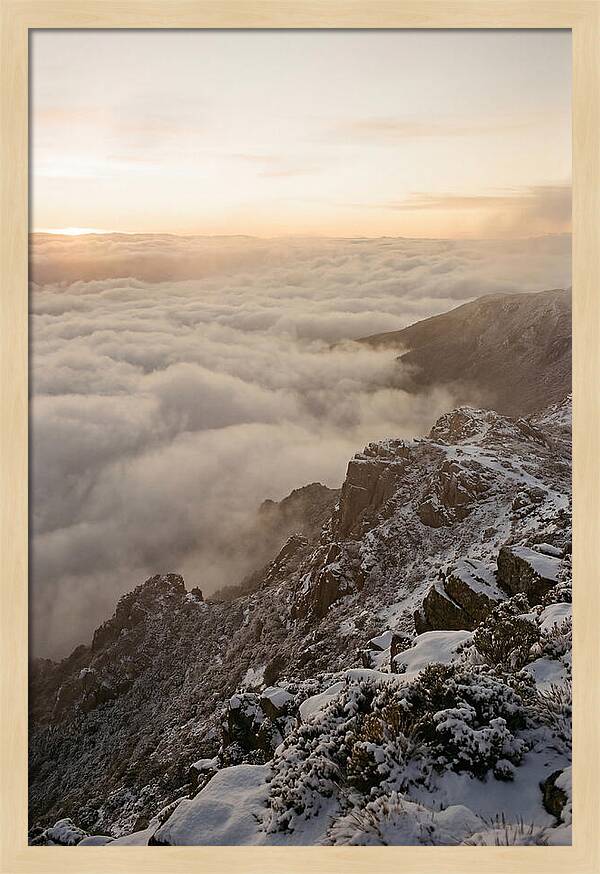 Snow Covered Ridge Line Above Sea Of Clouds