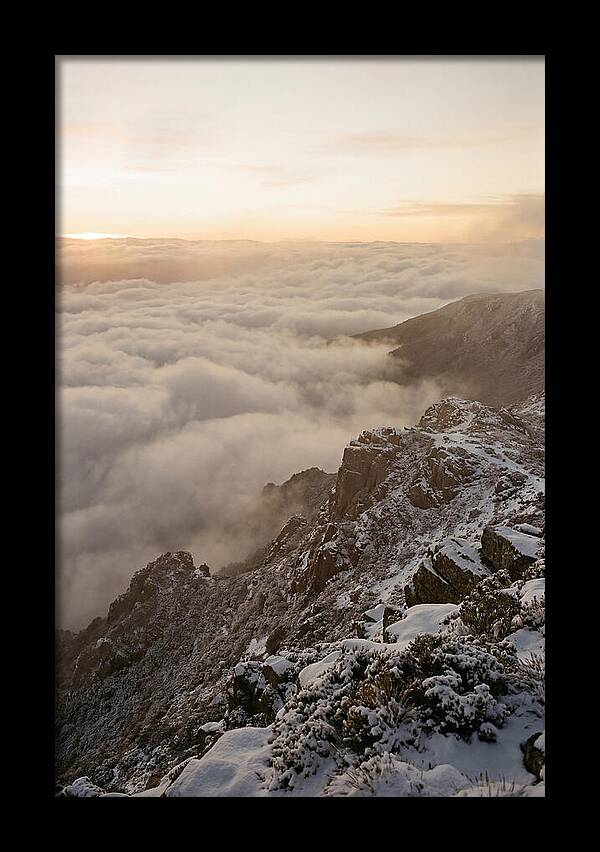 Snow Covered Ridge Line Above Sea Of Clouds